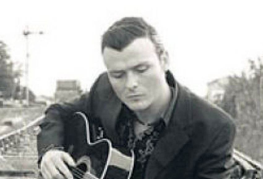 Michael McGarry singing with guitar